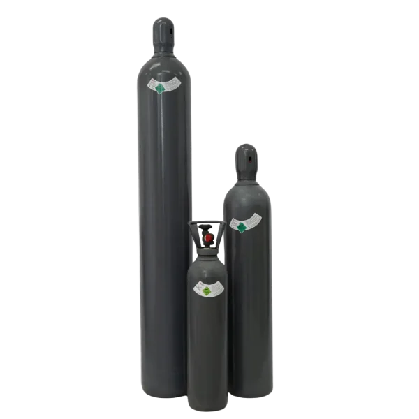 Three black gas cylinders of varying sizes stand vertically against a dark background. Each displays a diamond-shaped green label near the top.